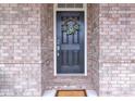 Classic front door with wreath set against a brick facade, providing a welcoming entrance at 6179 Ashbranch Dr, Acworth, GA 30101
