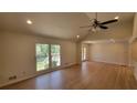 Bright living room with hardwood floors, vaulted ceiling, recessed lighting, and large window at 1978 Fisher Trl, Atlanta, GA 30345