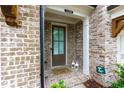 Inviting front entrance with a brick facade, decorative lanterns, and 'welcome home' mat at 2006 Towneship Trl, Roswell, GA 30075