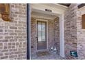Inviting front entry featuring a brick facade, and a charming welcome mat at 2006 Towneship Trl, Roswell, GA 30075