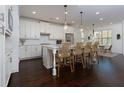 Bright kitchen with white cabinets, stainless steel appliances, pendant lighting, and a center island with seating at 2006 Towneship Trl, Roswell, GA 30075