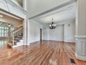 Spacious living room with hardwood floors, decorative molding, and ample natural light at 414 Candler Trl, Canton, GA 30115