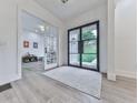 Inviting foyer with a modern black door and a view into an adjacent playroom at 106 Belmont Dr, Canton, GA 30115