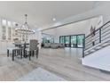 Bright, open-concept living and dining area with hardwood floors, large windows, and modern chandelier lighting at 106 Belmont Dr, Canton, GA 30115