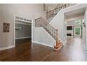 Spacious foyer with hardwood floors, staircase, and views into the formal living spaces at 1758 Rosehedge Nw Way, Kennesaw, GA 30152