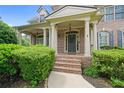 Charming covered front porch with brick steps and stately columns leads to the home's welcoming entrance at 1758 Rosehedge Nw Way, Kennesaw, GA 30152