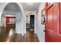 Inviting entryway featuring hardwood floors, arched doorways, and a striking red front door at 230 King Arthur Dr, Woodstock, GA 30189