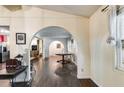 Open-concept living room with hardwood floors and arched entryways creating a spacious and bright atmosphere at 230 King Arthur Dr, Woodstock, GA 30189