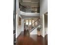 Elegant foyer with hardwood floors, a staircase, and a view to the living room at 970 Tarpley Nw Rd, Kennesaw, GA 30152