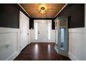 Home foyer featuring wood floors and ceiling, and custom cabinet at 137 Cambridge Pointe, Villa Rica, GA 30180