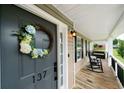 Charming front porch with rocking chairs, wreath, and address number at 137 Cambridge Pointe, Villa Rica, GA 30180