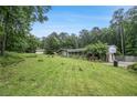Spacious property featuring a single-Gathering home, detached garage, and expansive green lawn at 2549 Emerald Dr, Jonesboro, GA 30236