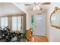 Inviting foyer with hardwood floors, decorative mirror, and natural light streaming through a glass-paneled front door at 2549 Emerald Dr, Jonesboro, GA 30236