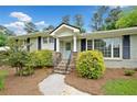 Inviting front entrance with stone steps, blue door, and well-manicured landscaping at 3019 Haverford Se Ln, Marietta, GA 30067