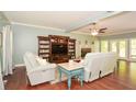 Cozy living room with hardwood floors, neutral paint, a decorative fireplace and comfortable seating at 49 Timberlake Ne Cv, Cartersville, GA 30121