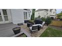 Backyard patio features a stone surface, comfortable outdoor seating, and a grilling area at 530 Veranda Ct, Alpharetta, GA 30009