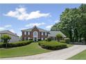 Charming brick home with a well-maintained lawn, driveway, and mature trees offering curb appeal at 530 Veranda Ct, Alpharetta, GA 30009