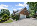 Brick home featuring an attached two car garage and well manicured landscaping at 530 Veranda Ct, Alpharetta, GA 30009
