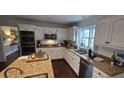 Bright kitchen with granite countertops, stainless steel appliances, and custom white cabinets at 530 Veranda Ct, Alpharetta, GA 30009