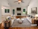 Bright living room featuring a fireplace, large windows and hardwood floors at 575 Freeman Dr, Covington, GA 30016
