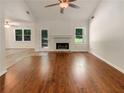Bright living room featuring a fireplace, large windows and hardwood floors at 575 Freeman Dr, Covington, GA 30016