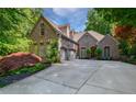 Two-story brick home featuring an attached two-car garage and landscaped front yard at 1255 Beech Haven Ne Rd, Atlanta, GA 30324