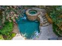 Aerial view of a tranquil pool and spa area, surrounded by lush greenery and stone accents at 1255 Beech Haven Ne Rd, Atlanta, GA 30324