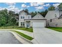 Charming two-story home featuring a manicured lawn and a two-car garage at 2505 Whistler Way Ne, Lawrenceville, GA 30043
