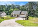 Well-maintained single-story home with attached garage, spacious lawn, and mature trees at 267 Rocky Point Rd, Covington, GA 30014