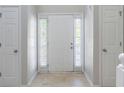 Bright entryway featuring a white front door, sidelights, and neutral-toned flooring at 3075 Oakvale Hts, Decatur, GA 30034