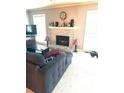Cozy living room with brick fireplace and neutral carpeting, perfect for relaxing at 104 Abingdon Way, Atlanta, GA 30328