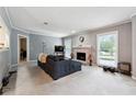 Bright living room with fireplace, large window, and a comfortable gray sofa at 104 Abingdon Way, Sandy Springs, GA 30328