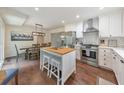 Modern kitchen features an island, stainless steel appliances, and a dining area with natural light at 138 Hartwood Dr, Woodstock, GA 30189