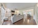 Bright living room boasts hardwood floors, built-in shelves, and an open layout to the dining area at 138 Hartwood Dr, Woodstock, GA 30189