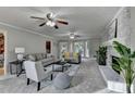 Spacious living room with brick fireplace, plush gray carpet, neutral paint and lots of natural light at 1486 Maple Ridge Dr, Suwanee, GA 30024