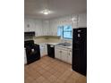 Functional kitchen with black appliances and white cabinetry, ready for culinary adventures at 604 Pepperwood Ln, Stone Mountain, GA 30087