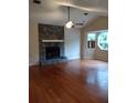 Spacious living room featuring a stone fireplace, vaulted ceiling, and hardwood floors at 604 Pepperwood Ln, Stone Mountain, GA 30087