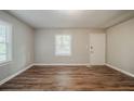 Bright bedroom featuring wood flooring, a window, and freshly painted walls at 3731 Adkins Nw Rd, Atlanta, GA 30331