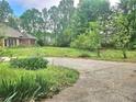 Circular driveway with lush greenery on a large private lot at 4855 West Price Rd, Sugar Hill, GA 30518
