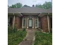 Front entrance of brick home featuring a charming front door and elegant exterior details at 4855 West Price Rd, Sugar Hill, GA 30518
