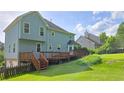 Expansive backyard featuring a wooden deck, ideal for relaxation and gatherings, with a lush lawn at 4905 Puritan Dr, Sugar Hill, GA 30518