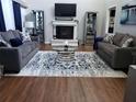 Beautiful living room with hardwood floors, stylish furniture, and a cozy fireplace at 6070 Ridge Way, Douglasville, GA 30135
