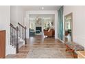 Inviting foyer with hardwood floors, staircase, and an open view to the living area at 1048 Shadow Glen Dr, Fairburn, GA 30213