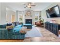 Cozy living room showcasing a fireplace, a large TV, and elegant decor at 1048 Shadow Glen Dr, Fairburn, GA 30213