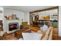 Cozy living room with fireplace opens to a modern kitchen, and features hardwood floors at 10975 Hutcheson Ferry Rd, Chattahoochee Hills, GA 30268