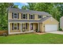 Inviting two-story home featuring a covered front porch and attached two-car garage at 1380 Heritage Glen Dr, Marietta, GA 30068