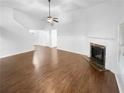 Bright living room with fireplace and hardwood floor before virtual staging at 2586 Gristhaven Ln, Buford, GA 30519