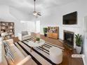 Bright living room with fireplace, ceiling fan, and modern furniture arrangement after virtual staging at 2586 Gristhaven Ln, Buford, GA 30519