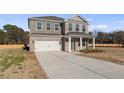 Two-story brick home featuring an attached garage, driveway, and a well-maintained lawn at 124 Dalston Cv, Stockbridge, GA 30281