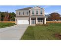 Beautifully landscaped two-story brick home with attached garage and inviting curb appeal at 124 Dalston Cv, Stockbridge, GA 30281